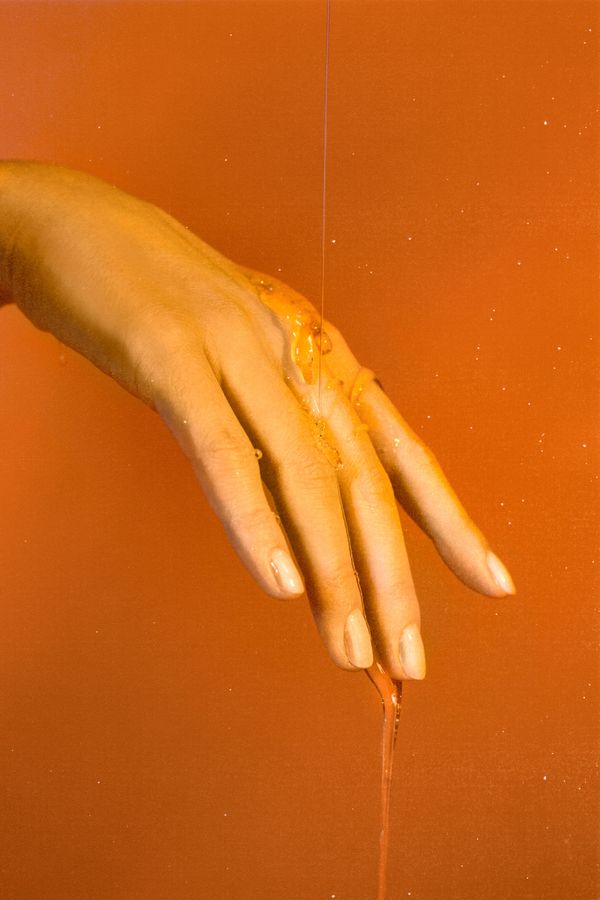 Honey dripping off a hand 