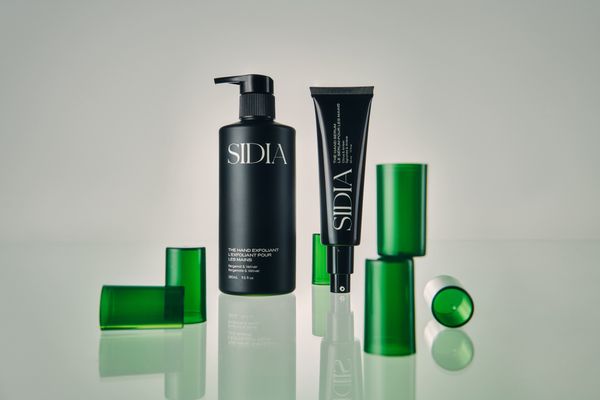 Sidia's The Hand Exfoliant and The Hand Serum displayed next to green caps