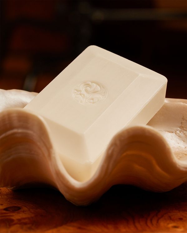 An Oribe soap bar in a wavy bowl