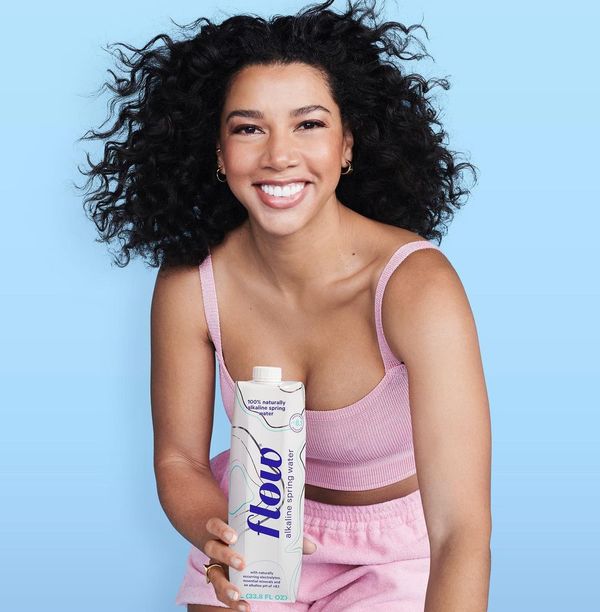 Hannah Bronfman posed holding a bottle of Flow water