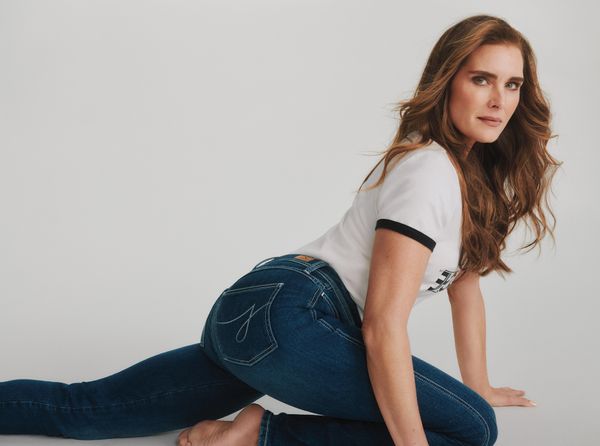 Brooke Shields posed in a low lunge wearing dark denim and a t-shirt 