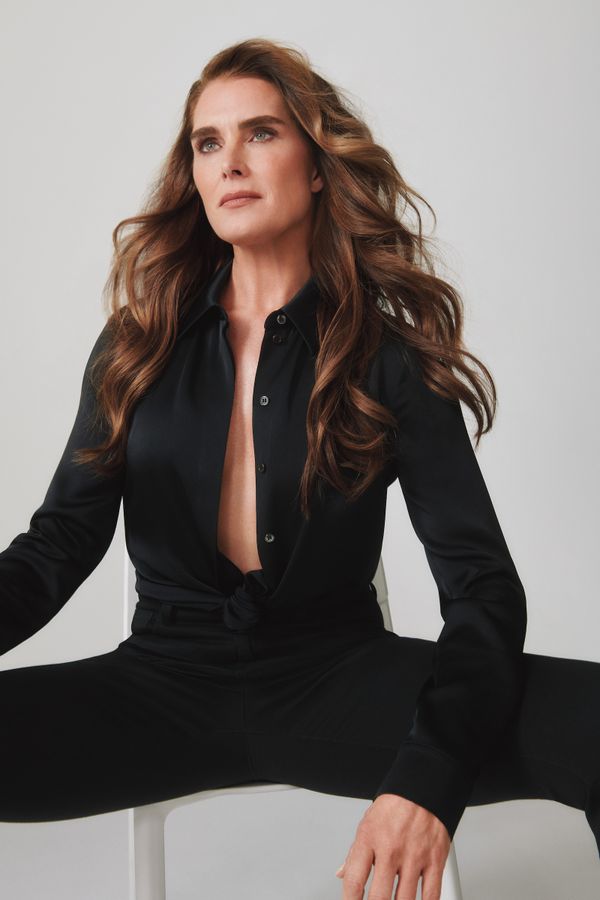 Brooke Shields sitting and wearing an all black outfit 