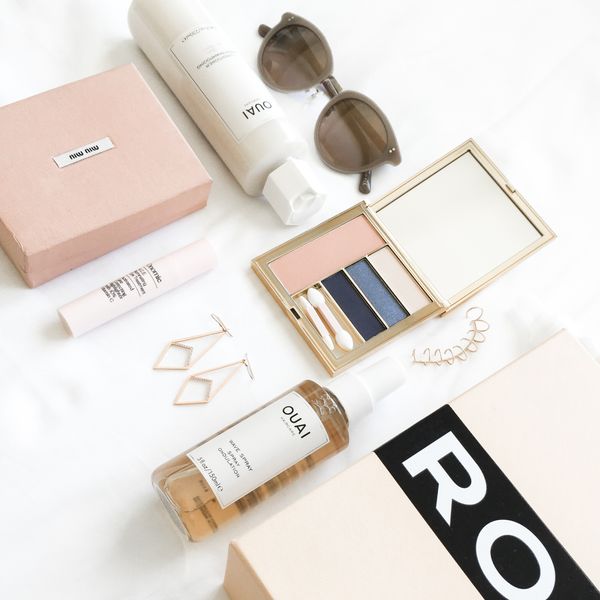 OUAI products organized next to fashion accessories and boxes 