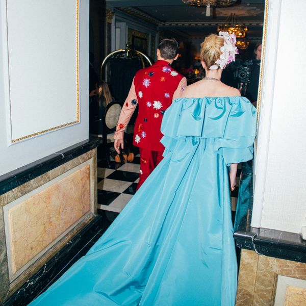 Lili Reinhart and Cole Sprouse walking away in colourful, camp-inspired outfits